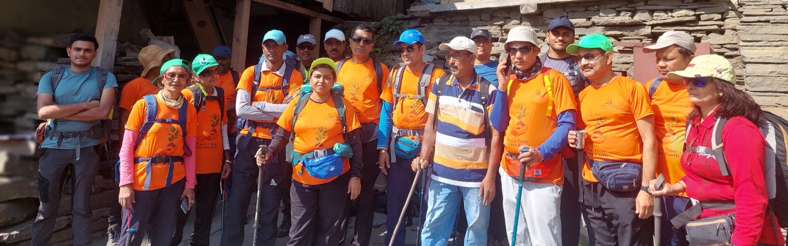 Corporate team trekking in mountains - team building outdoor activity