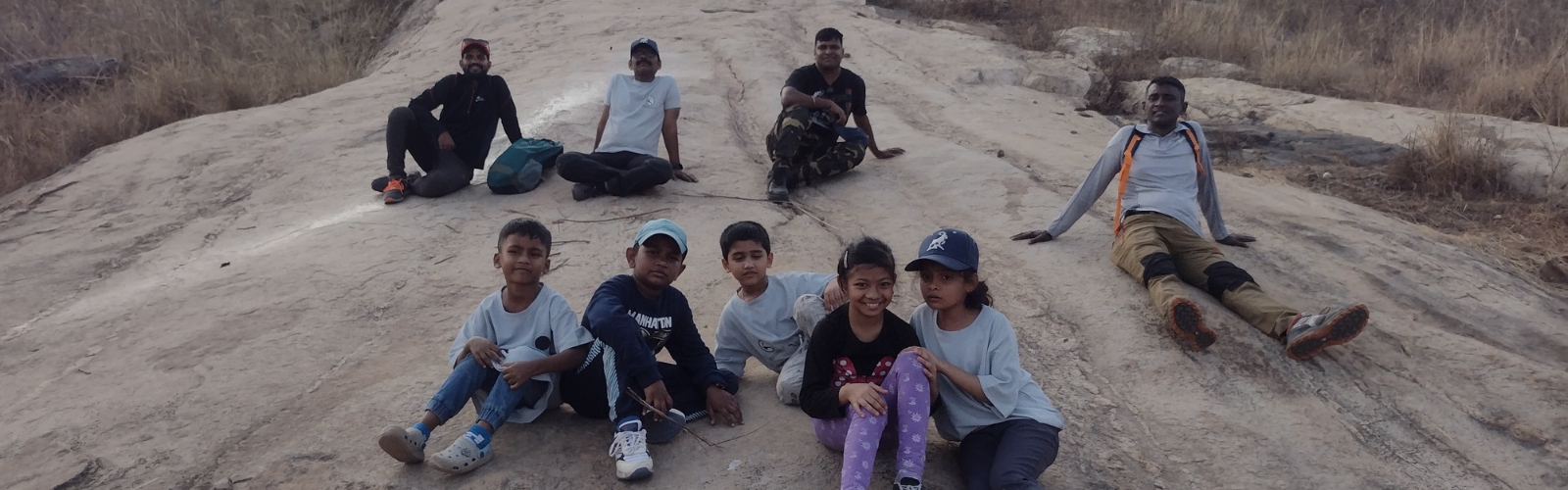 Group of school children hiking on a forest trail during educational trip